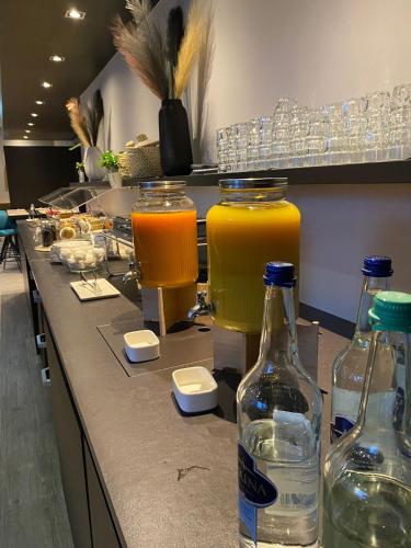 a counter with three bottles of drinks on it at Ibis Lugano Paradiso in Lugano