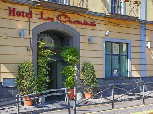 a hotel building with a sign on the front of it at Le Cheminée Business Hotel Napoli in Naples