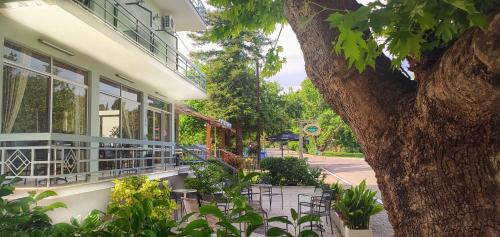 a building with windows and plants in front of it at Ermis in Loutra Ipatis