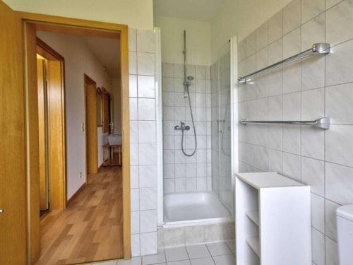 a bathroom with a shower and a bath tub at By the golf course in Wulfen on Fehmarn in Fehmarn
