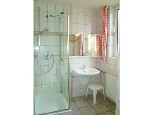 a bathroom with a sink and a glass shower at on the beach no 991 in Wulfen auf Fehmarn
