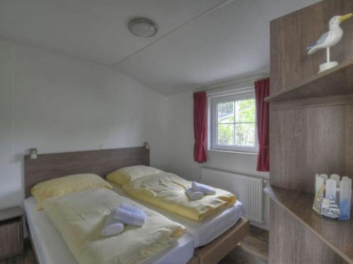 a bedroom with two beds and a bird on the wall at Seemöwe "Seagull" F178 in Fehmarn