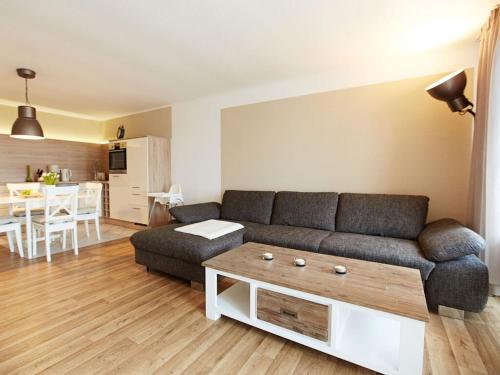 a living room with a couch and a table at Strandeck Comfortable holiday residence in Göhren