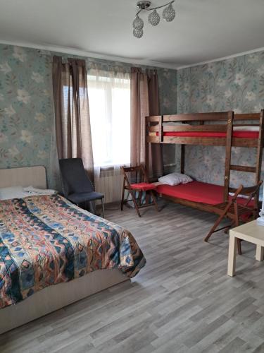 a bedroom with two bunk beds and a chair at Sparta Apartments Kosmonaudi in Narva