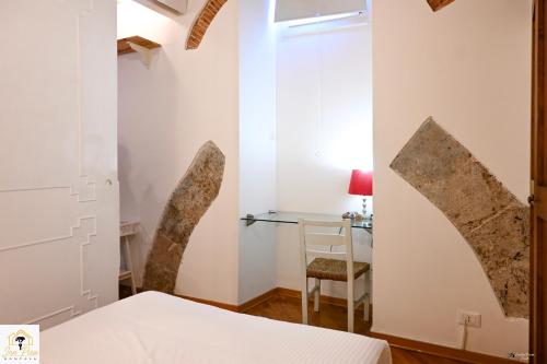 a bedroom with a bed and a chair and a desk at Inn Pisa Rentals 2- In The Heart of Pisa in Pisa
