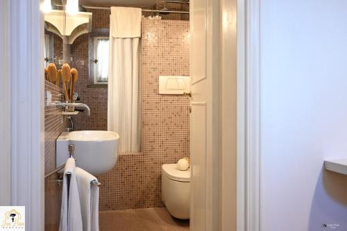 a bathroom with a toilet and a sink at Inn Pisa Rentals 2- In The Heart of Pisa in Pisa