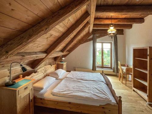 a bedroom with a large bed in an attic at Landgoed Vier Seizoenen in Wangen im Allgäu