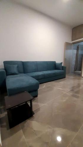 a blue couch sitting in a living room at Villa Mike in Amarinthos