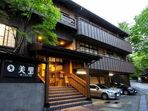 a building with a car parked in front of it at Ryokan Misato in Minamioguni