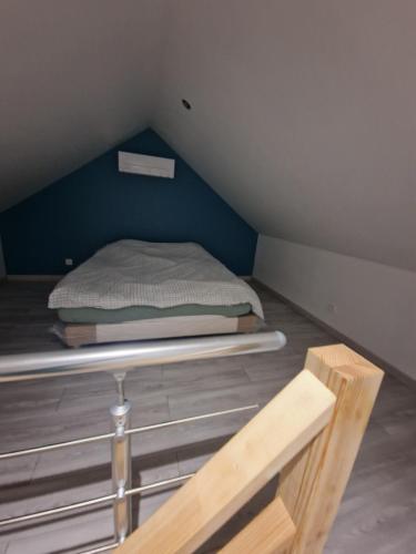 a small room with a bed in the attic at Maisons au cœur du berry in Venesmes