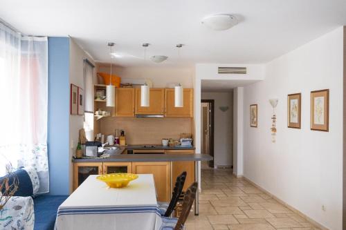 eine Küche und ein Esszimmer mit einem Tisch im Zimmer in der Unterkunft Apartment Omnia in Kaliakria Resort in Topola