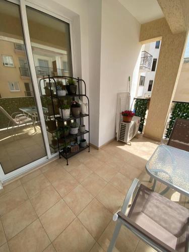 a room with a balcony with a plant shelf at 2 Bedroom Apartment, Zygos Centre Block D - By IMH Travel & Tours in Paphos City