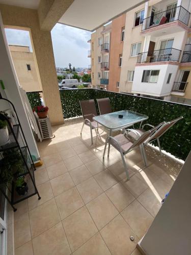 a patio with a table and chairs on a balcony at 2 Bedroom Apartment, Zygos Centre Block D - By IMH Travel & Tours in Paphos City