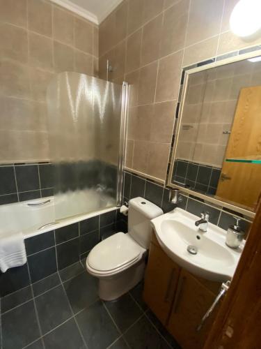 a bathroom with a toilet and a sink and a mirror at 2 Bedroom Apartment, Zygos Centre Block D - By IMH Travel & Tours in Paphos City