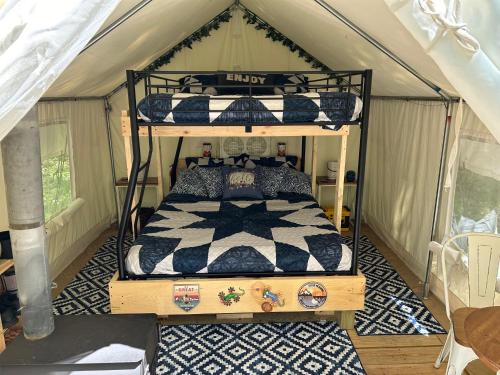 a bedroom with two bunk beds in a tent at Red Creek Hideaway in Cooperstown NY in Cooperstown