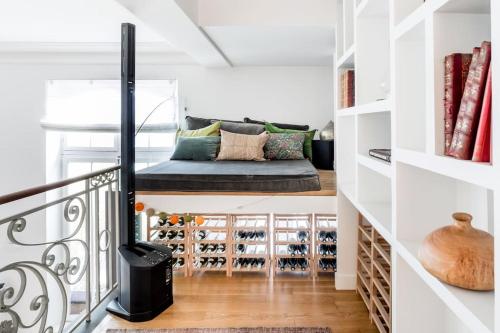 une pièce avec un canapé dans un escalier avec des casiers à vin dans l'établissement Magnificent Loft Apartment in the Latin Quarter, à Paris