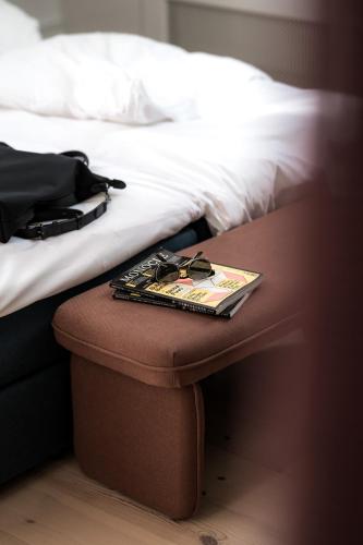 a tray of glasses sitting on a table next to a bed at The Nyhavn Penthouse by Daniel&Jacob's in Copenhagen