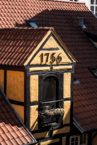 a clock on the side of a building at The Nyhavn Penthouse by Daniel&Jacob's in Copenhagen