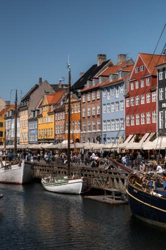 a group of boats docked in a harbor with buildings at The Nyhavn Penthouse by Daniel&Jacob's in Copenhagen
