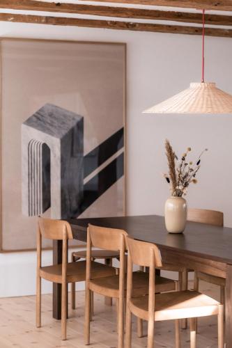 a dining room with a wooden table and chairs at The Nyhavn Penthouse by Daniel&Jacob's in Copenhagen