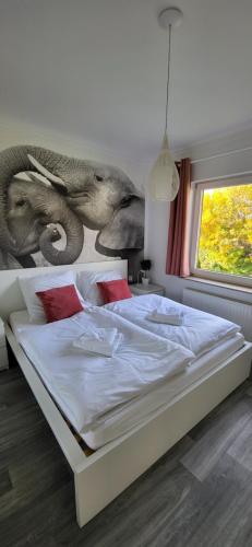 a bedroom with a bed with an elephant mural on the wall at D&B staycation Resort in Niedenstein