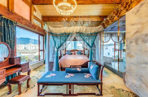 Lijiang Shuhe Zuo'an Inn في ليجيانغ: غرفة نوم بسرير ومكتب ونافذة