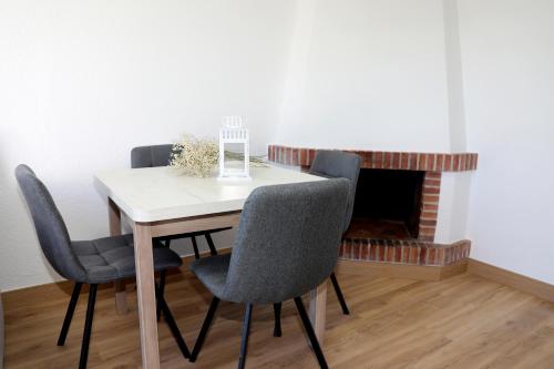 a dining room table with chairs and a fireplace at Duplex Mojácar Beach in Mojácar