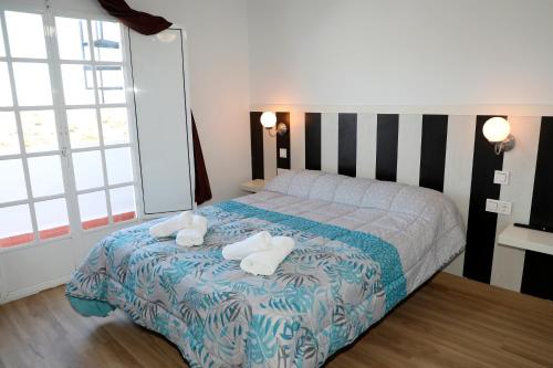 a bedroom with a bed with towels on it at Duplex Mojácar Beach in Mojácar