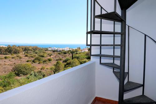 a spiral staircase in a house with a view at Duplex Mojácar Beach in Mojácar