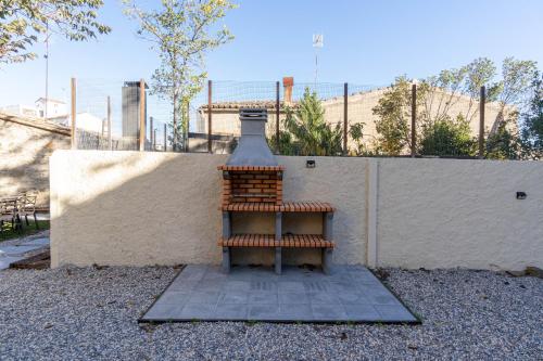a small fire hydrant sitting next to a wall at Cozy house in Priorat! Barbecue & Relax - Climbing & Views in Poboleda
