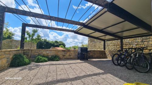 a garage with bikes parked under a roof at HIŠA KAPIŠ with HOT TUBE in Koper