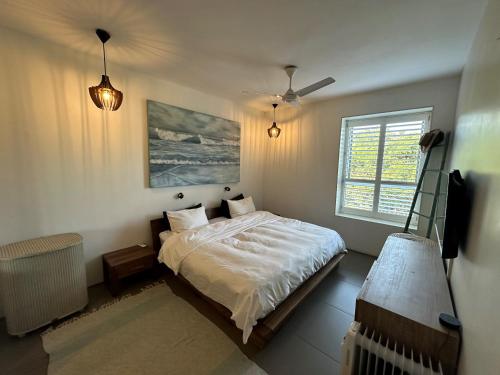 a bedroom with a bed and a window at 18 Forest Apartments, Dunkirk Estate in Sheffield Beach