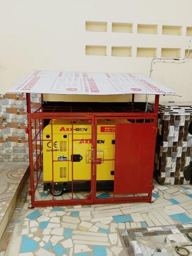 a yellow and red machine sitting on a floor at Villa Flo Residence in Lomé