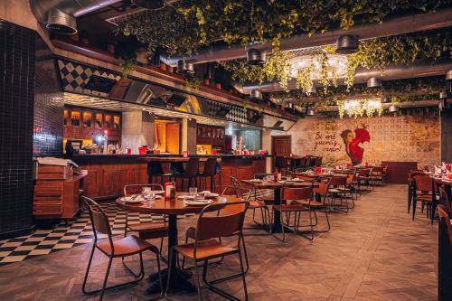 a restaurant with tables and chairs and a bar at TRYP by Wyndham Dubai in Dubai