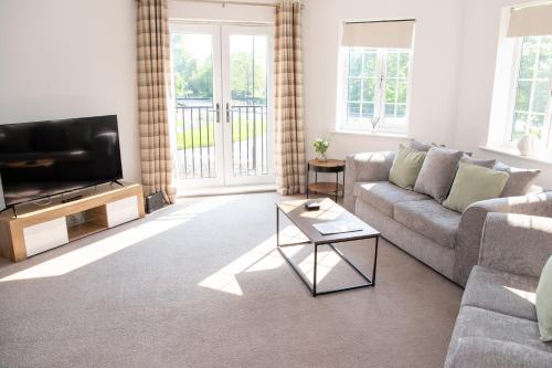 a living room with a couch and a tv at Spacious Retreat with Parking: Ideal for Families & Contractors in York