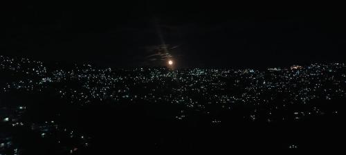 a view of a city at night at PINAK HOMESTAY in Almora