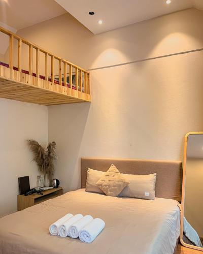 a bedroom with a bed with two towels on it at Love House Homestay SAPA in Sa Pa