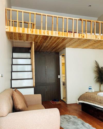 a living room with a loft bed and a couch at Love House Homestay SAPA in Sa Pa