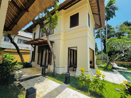 a house in the middle of a garden at Jimbaran Cozy Stay in Jimbaran