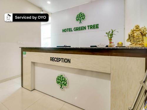 a hotel green tree sign on a counter in a store at Super Collection O Green Tree Near Beach Road in Alipur