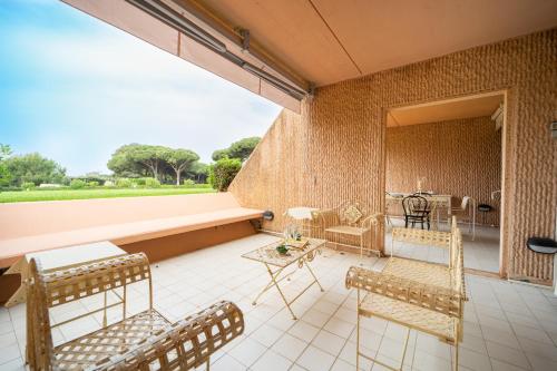 a patio with chairs and a table and a couch at Residence Scoglietto 50 in Punta Ala