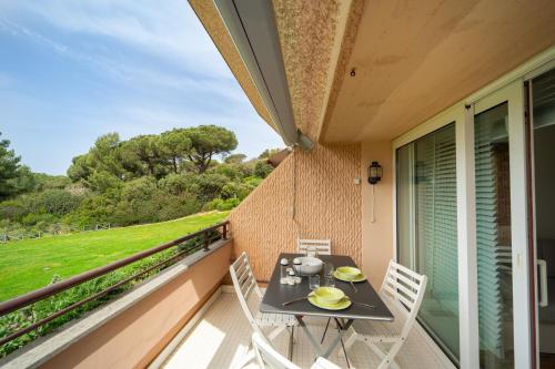 a balcony with a table and two chairs on it at Residence Scoglietto 50 in Punta Ala