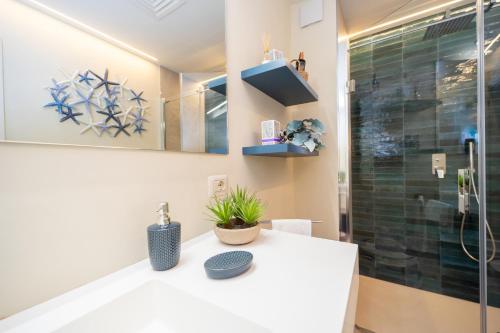a bathroom with a shower and a white counter top at Residence Scoglietto 50 in Punta Ala