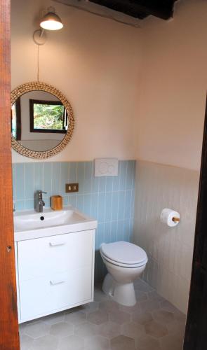 a bathroom with a toilet and a mirror at Cala Sinzias beach house with stunning views in Costa Rei