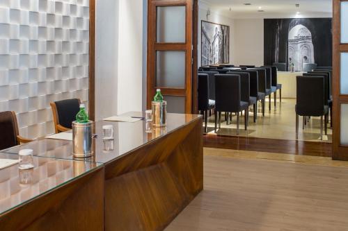 a bar with a row of chairs in a waiting room at Hotel Federico II Central Palace in Palermo