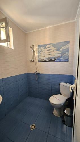 a bathroom with a toilet and a glass shower at Guest Rooms Kostovi in Nesebar