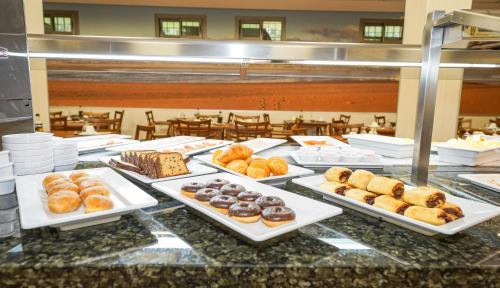 a buffet with many different types of donuts on plates at Hotel Pradillo Conil in Conil de la Frontera