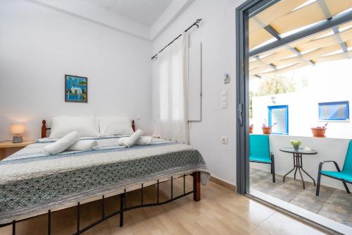 a bedroom with a large bed and a patio at FEEL THE SERENITY in Galini