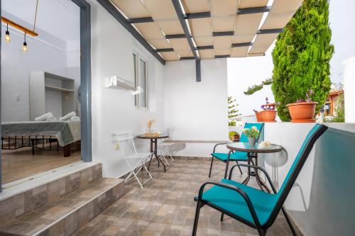 a patio with a table and chairs in a room at FEEL THE SERENITY in Galini
