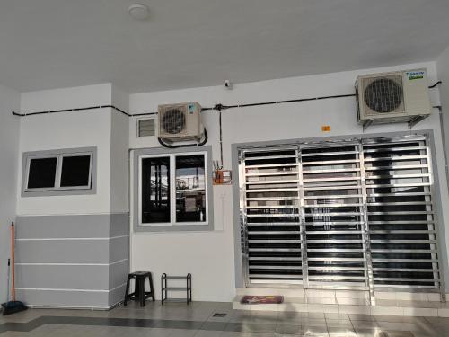 a room with two air conditioners and a window at My Homestay Sitiawan - Astronaut Space House 8 Pax in Sitiawan